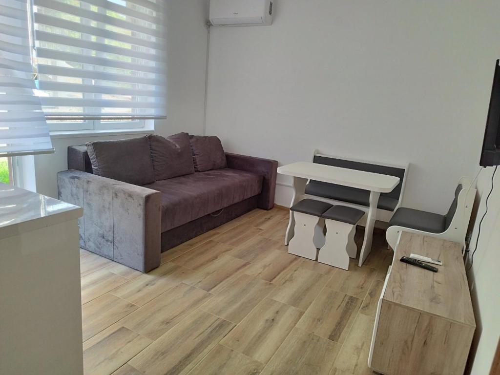 un soggiorno con divano e tavolo di Bora apartman a Soko Banja