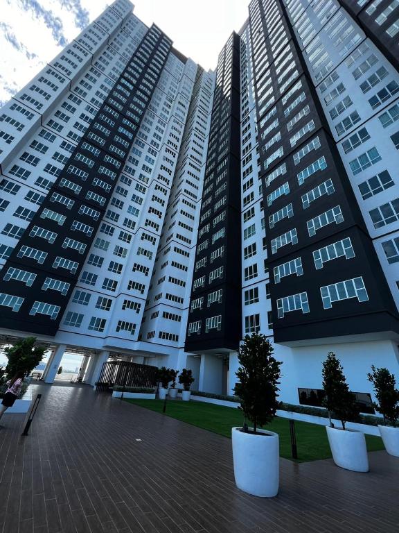 a large building with trees in front of it at Amber cove in Malacca