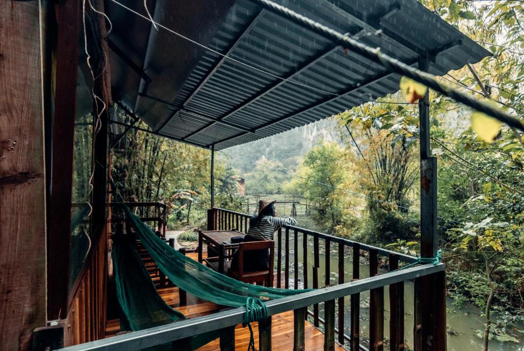 a hammock on the deck of a house at Chez Beo Homestay in Ninh Binh
