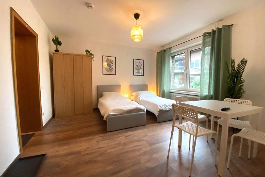 a small room with a bed and a table and a bedroom at Cozy Apartment in Oberhausen in Oberhausen