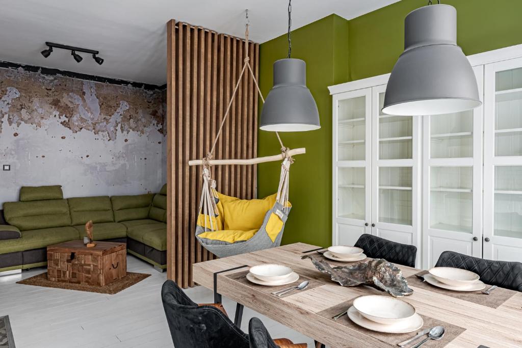 een eetkamer met een tafel en een bank bij Synagogue Central Kira Apartment in Boedapest