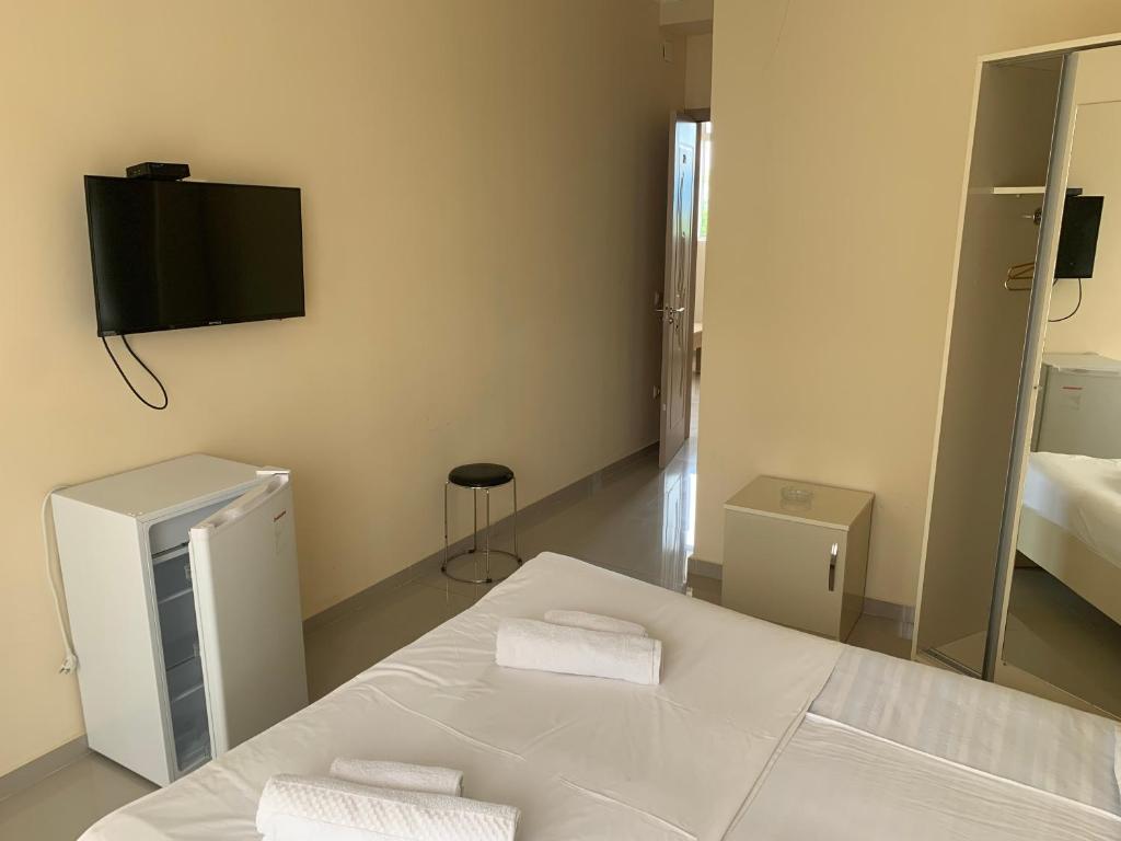 a bedroom with a bed and a tv on the wall at Kobuleti 424 in K'obulet'i