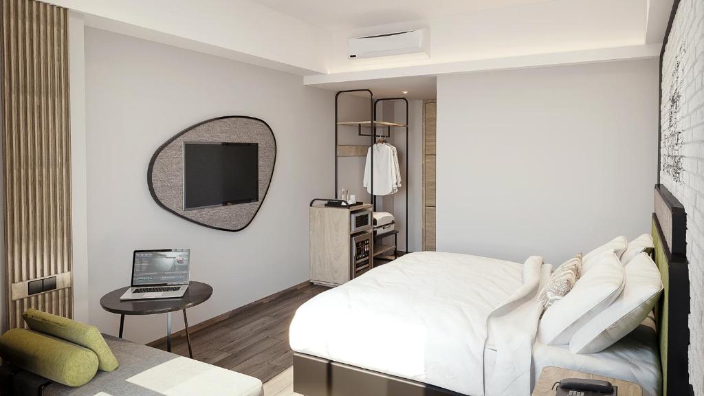 Postel nebo postele na pokoji v ubytování Luminor Hotel Padjadjaran Bogor by WH