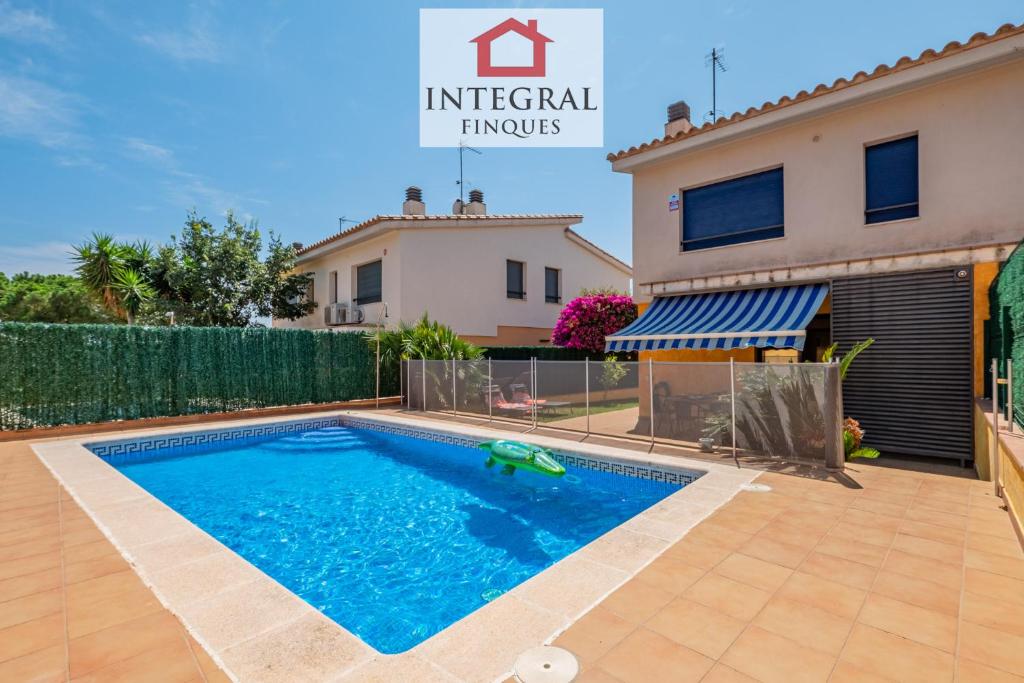 a villa with a swimming pool and a house at Casa Pool TimeOut in Palamós
