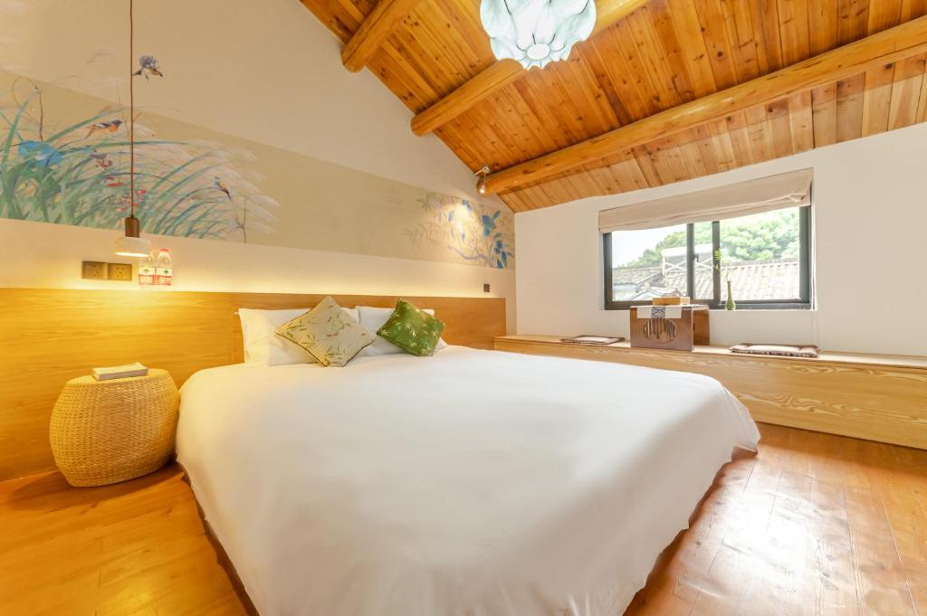 a bedroom with a large white bed in a room at MK Inn in Hangzhou