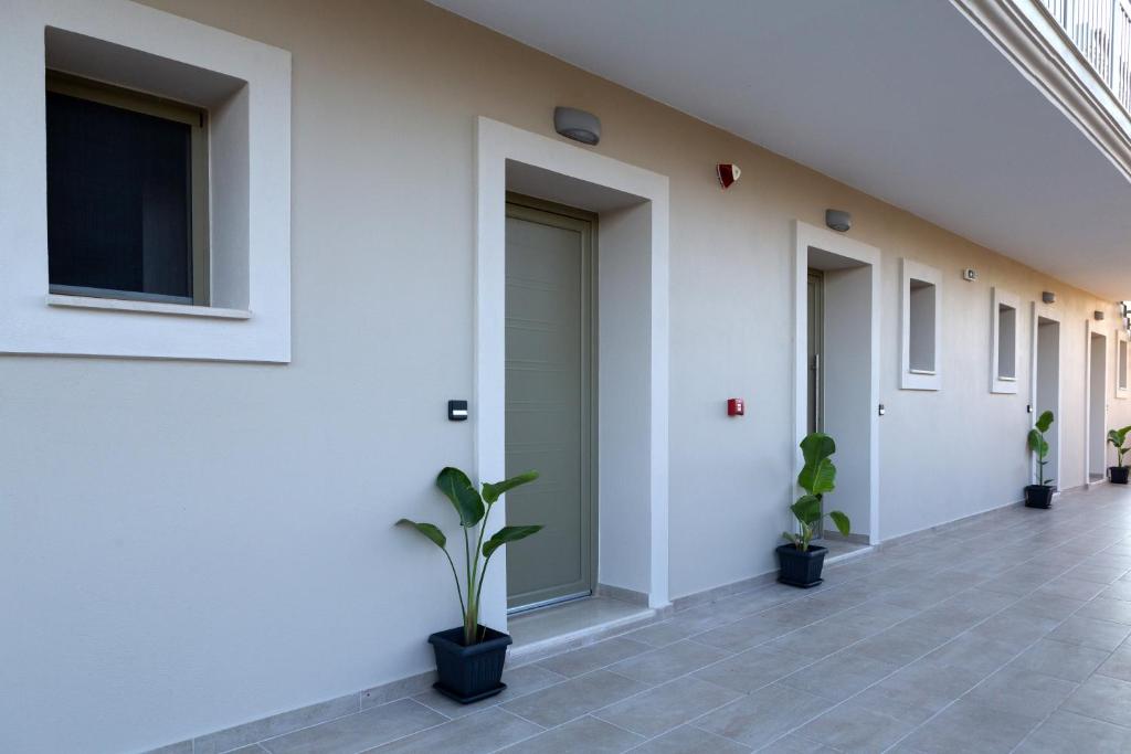 a hallway of a building with potted plants at Sky View Suites Kefalonia in Vóvikes