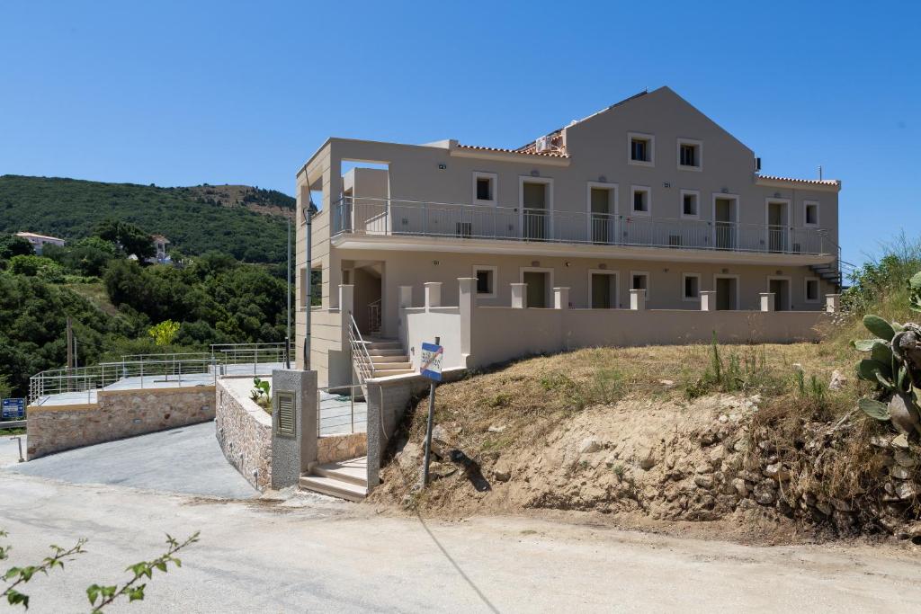 a large house on top of a hill at Sky View Suites Kefalonia in Vóvikes