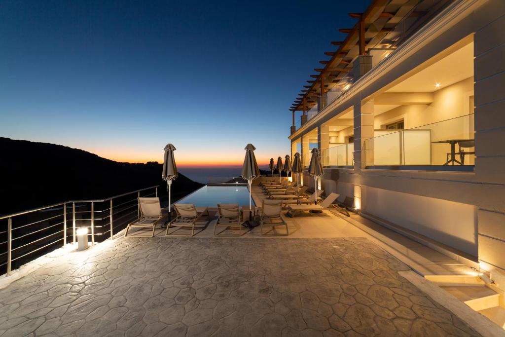 a view from the balcony of a house at night at Sky View Suites Kefalonia in Vóvikes