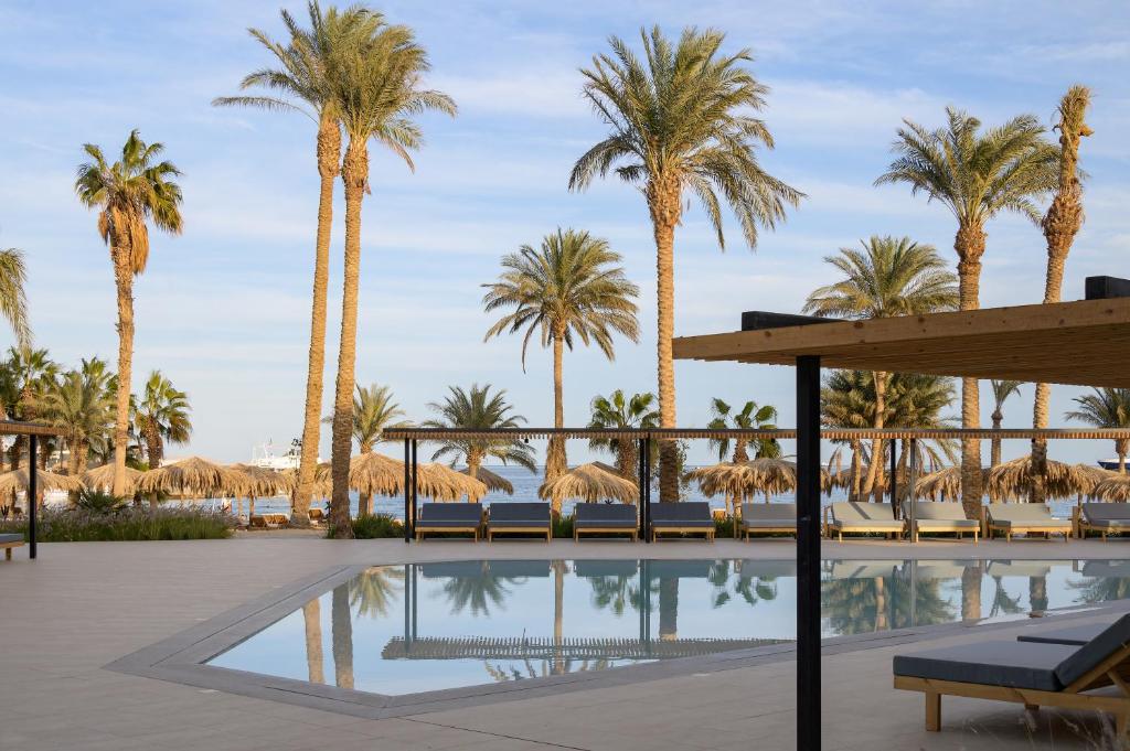 a resort with palm trees and a pool at Serry Beach Resort in Hurghada