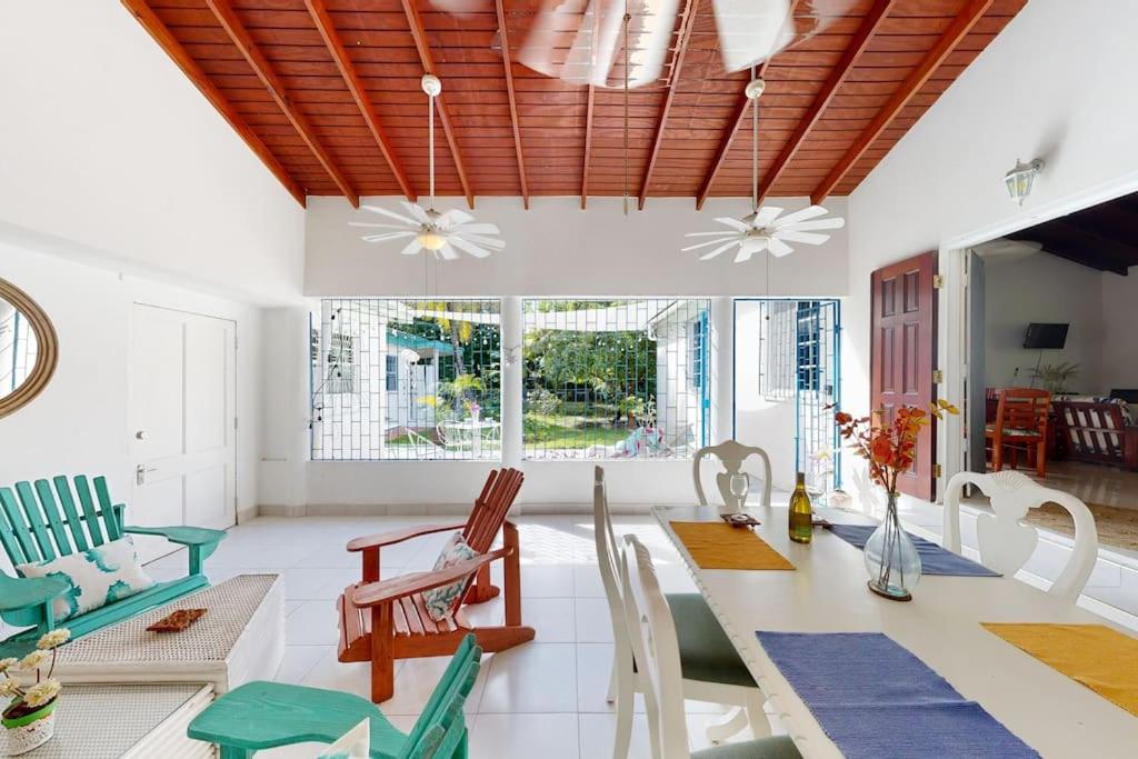 a living room with a table and chairs at Kismet Garden Cottages - Dover Beach in Christ Church