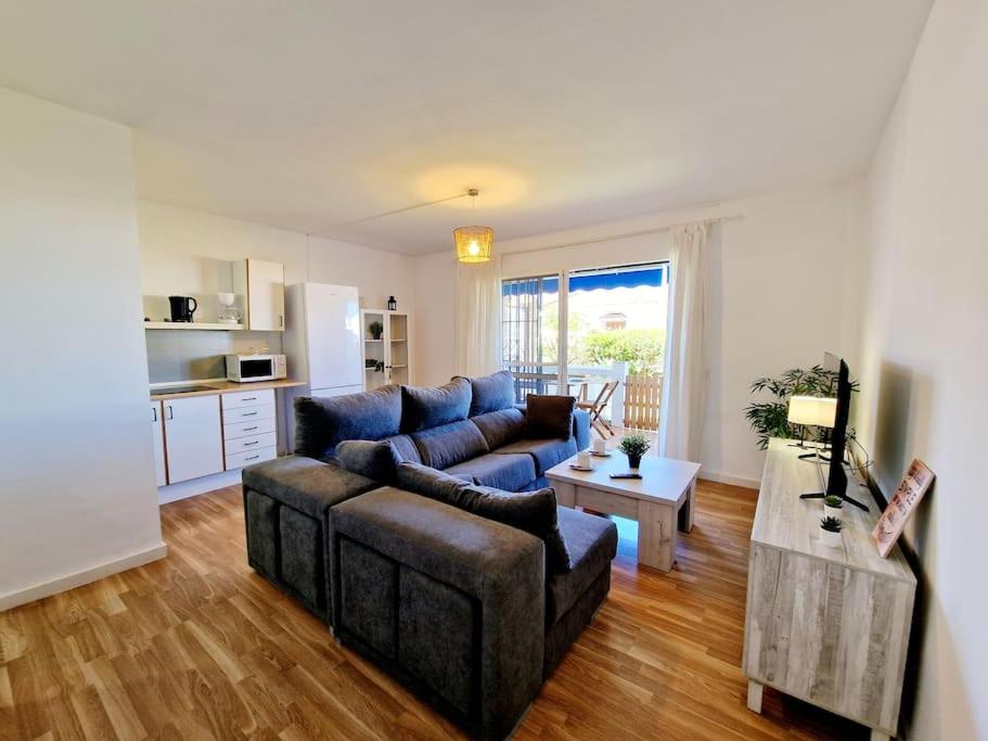 a living room with a couch and a table at Ground floor Apt in La Cala in Mijas Costa