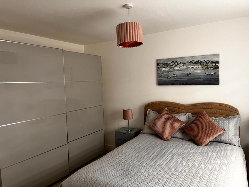 a bedroom with a bed and a pendant light at Double Room in a Family Home - 15 Minutes Walk to Famous Bicester Village in Chesterton