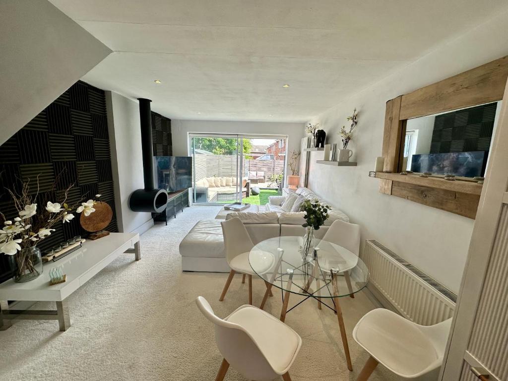 a living room with a couch and a table and chairs at Fantastic 2-Bed House with Parking - Hosted by Hutch Lifestyle in Leamington Spa
