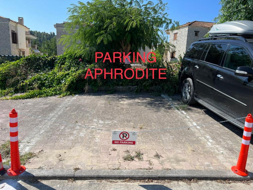 a car parked in a parking autopotide sign in a parking lot at Aphrodite Apartment ideal for holidays in Siviri in Siviri