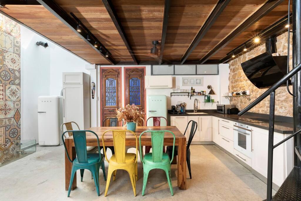 a kitchen with a wooden table and chairs at Luxury Villa by the Beach in Neve Tzedek's Heart! in Tel Aviv