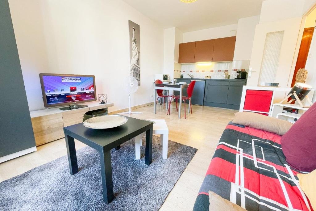 a living room with a couch and a table at The Grenoble Break #FQ in Grenoble