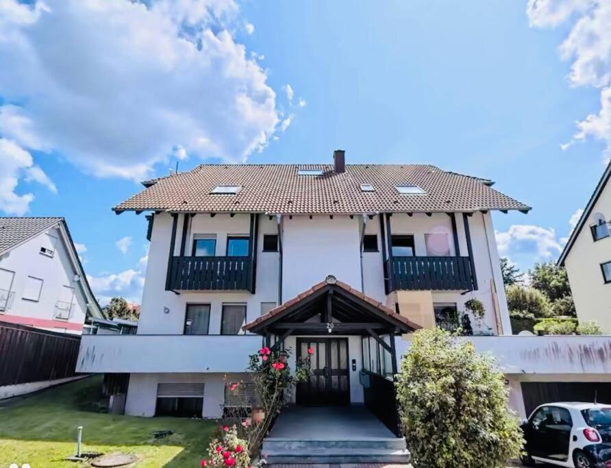 a large white house with a balcony at appartme. XS in Bad Herrenalb