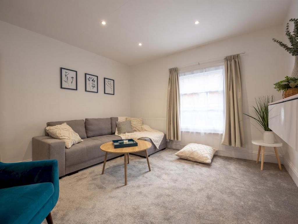 a living room with a couch and a table at Pass the Keys Modern Apartment with Terrace in Telford