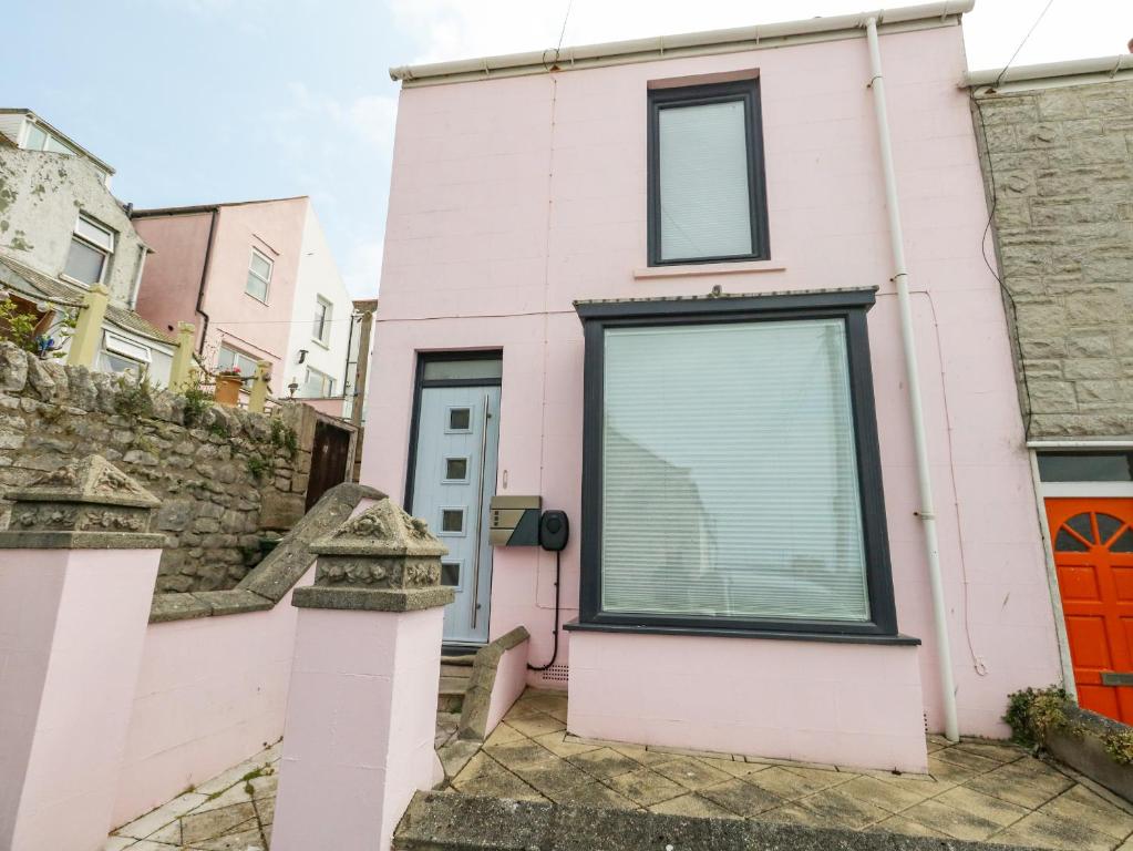 a pink house with a red door at Lyme View in Portland