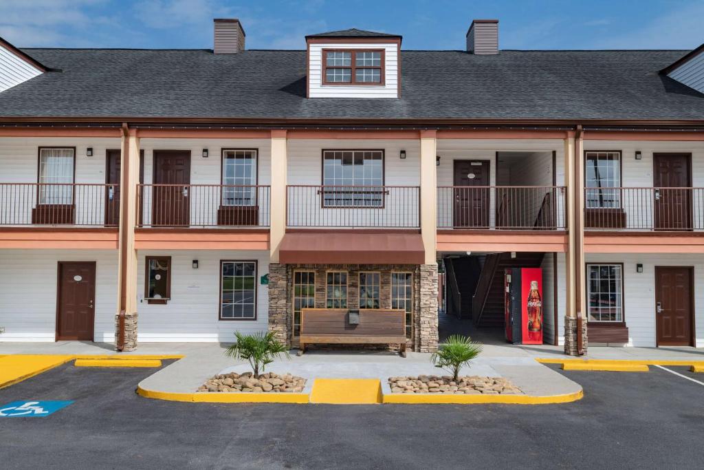 a building with a parking lot in front of it at Baymont by Wyndham Commerce GA Near Tanger Outlets Mall in Commerce