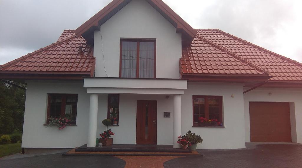 Casa blanca con techo rojo en Biały Domek, noclegi Gołdap, en Gołdap