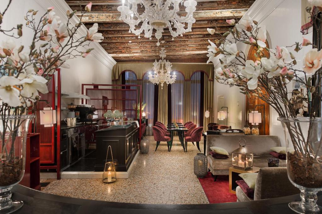 a living room with a chandelier and a dining room at Ca' Gottardi in Venice