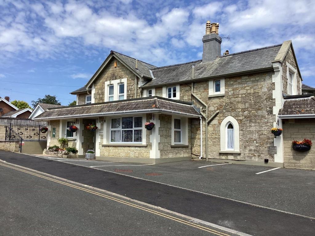 an old stone house on a street at Fernbank in Shanklin