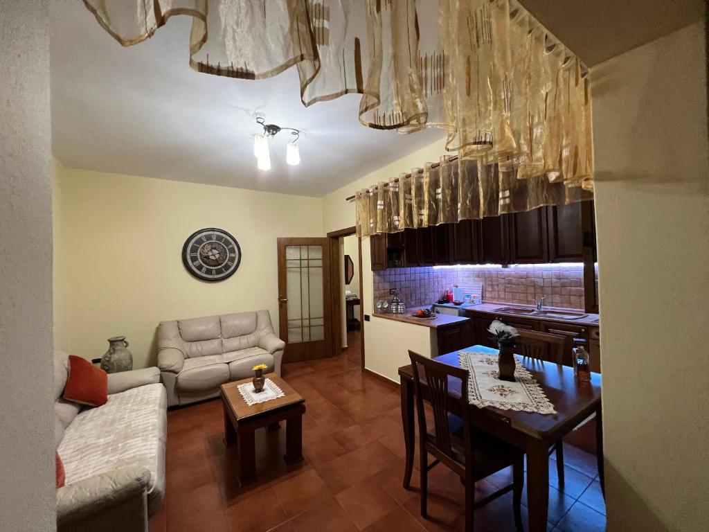 a kitchen and living room with a table and a couch at Apartament Qender in Elbasan