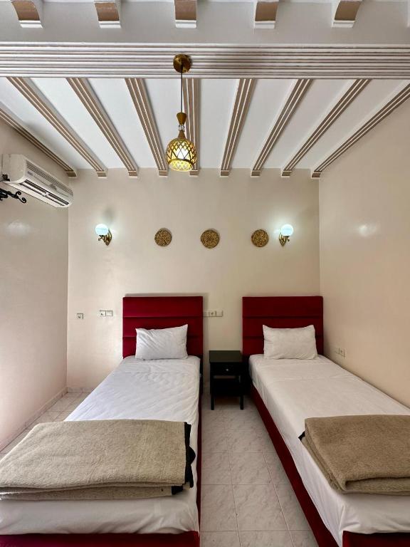 Postel nebo postele na pokoji v ubytování Hôtel Zaghro