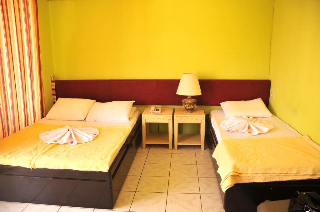 Postel nebo postele na pokoji v ubytování Sun Kiss Hotel