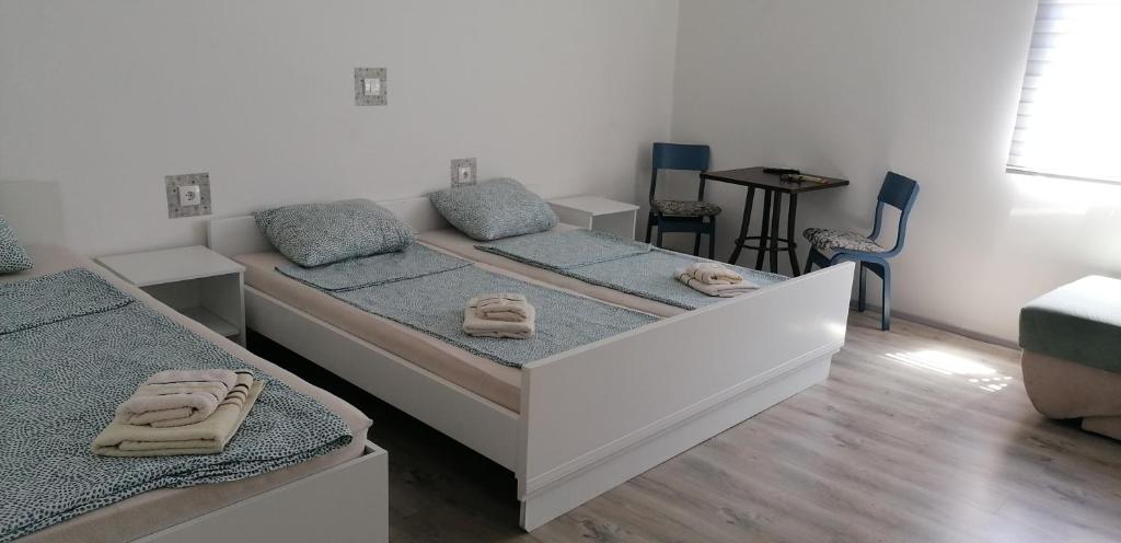 a bedroom with two beds with towels on them at Konak Aleksandar in Mladenovac
