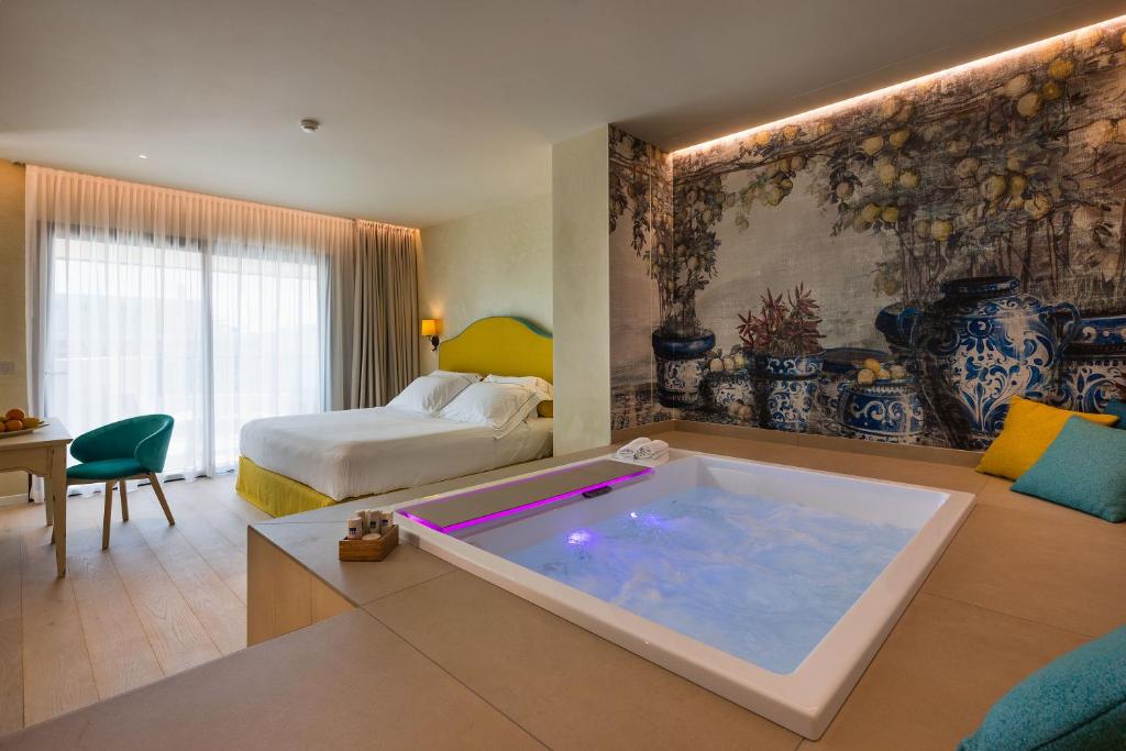 a hotel room with a large tub in a room at Savoy Beach Hotel & Thermal Spa in Bibione