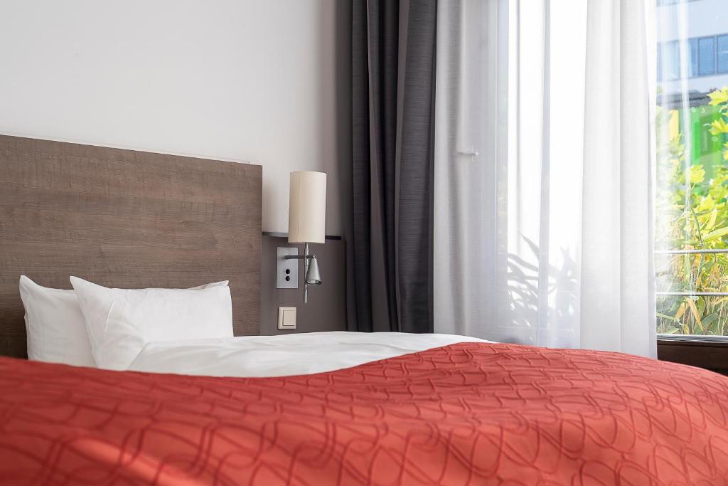 Postel nebo postele na pokoji v ubytování Art & Business Hotel