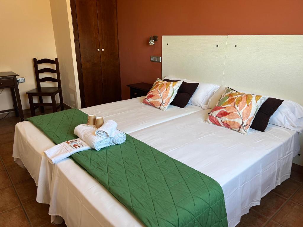 a bedroom with two beds with towels on them at HOSTAL TREVELEZ in El Ejido