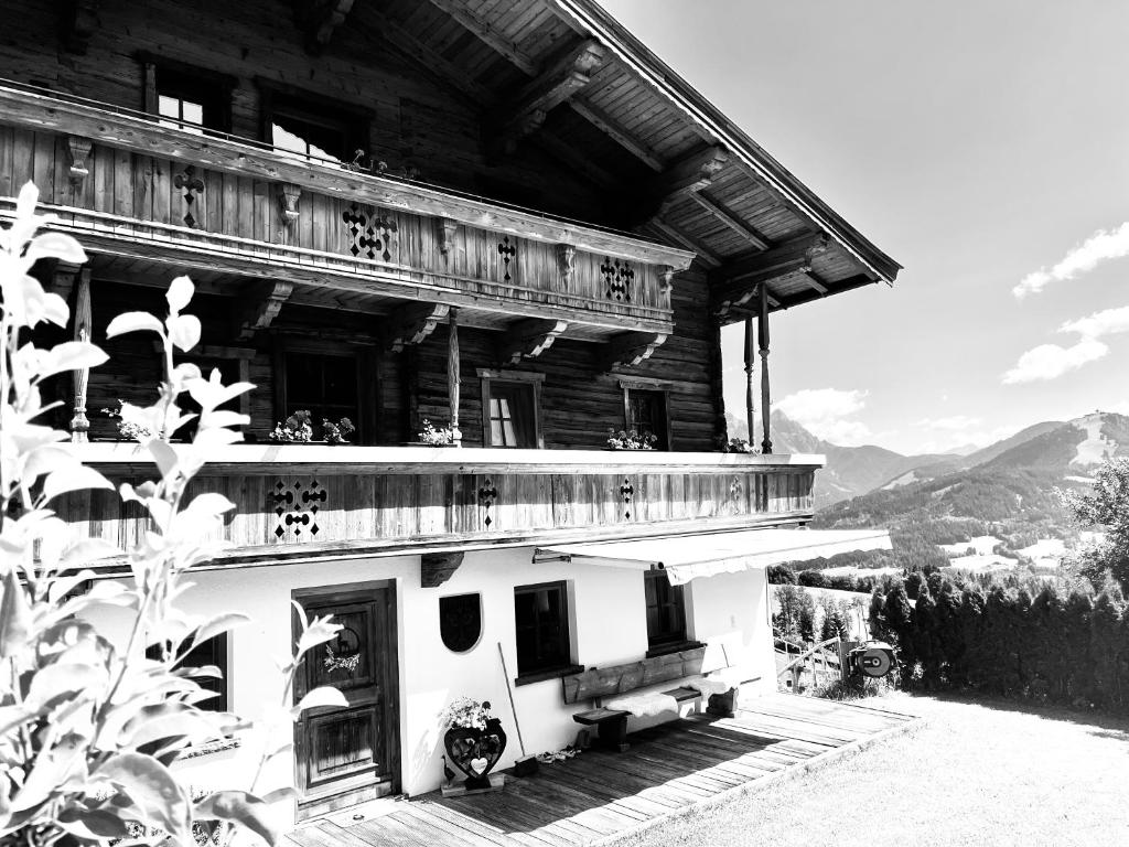 une photo en noir et blanc d'un bâtiment avec balcon dans l'établissement Bioberghof Rohr, à Fieberbrunn