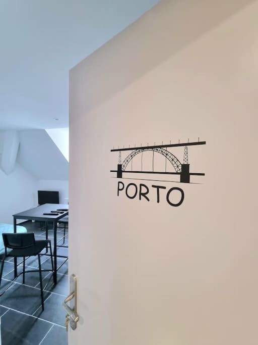 eine offene Tür mit einem Tisch und Stühlen in einem Zimmer in der Unterkunft Le Porto - Studio gare in Mulhouse