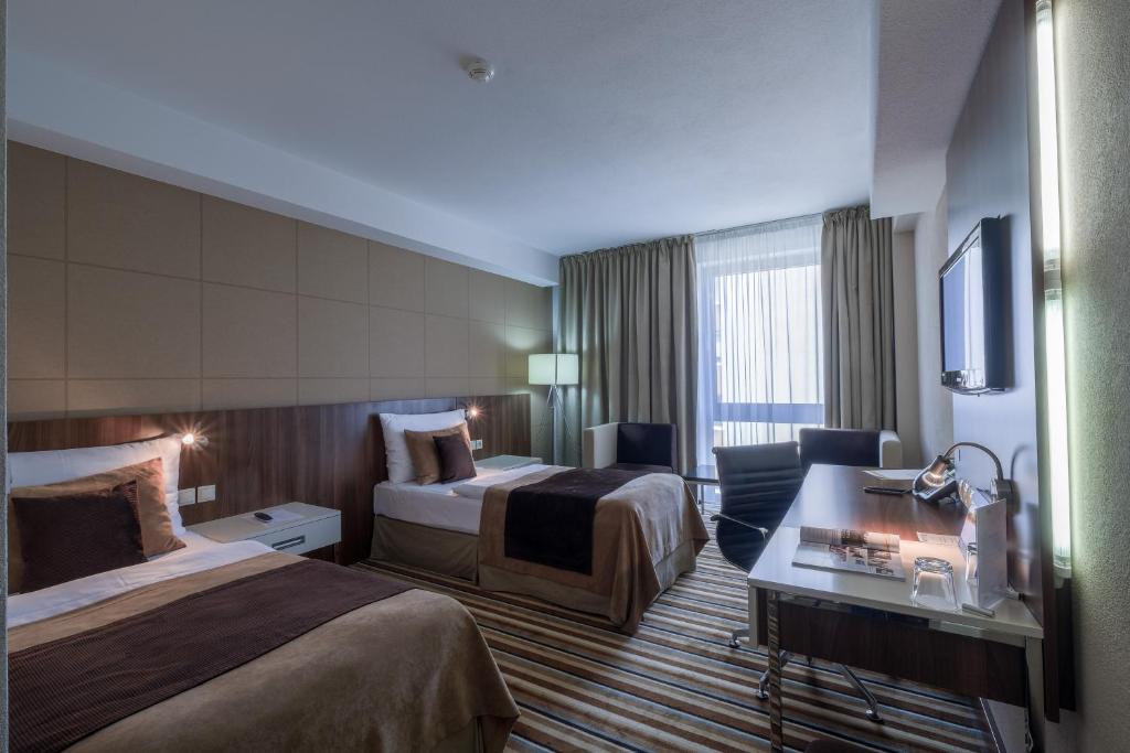Postel nebo postele na pokoji v ubytování Business Hotel Astrum Laus