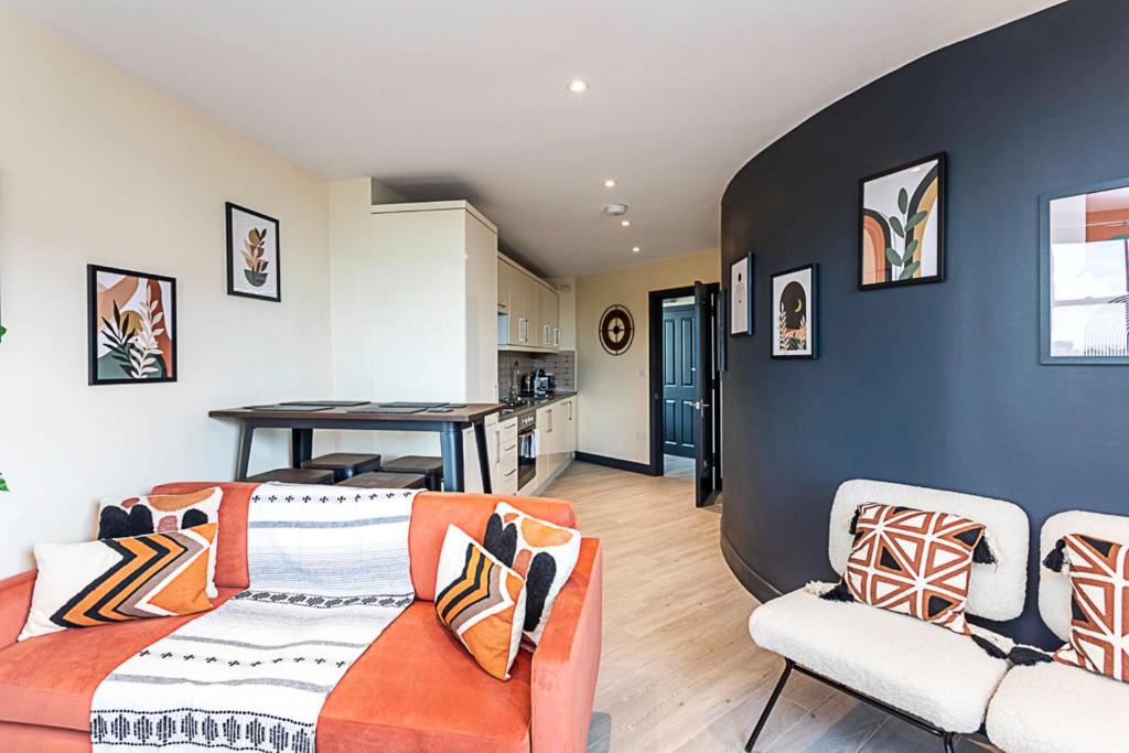 a living room with two couches and a kitchen at Crystal Palace Residence II in London