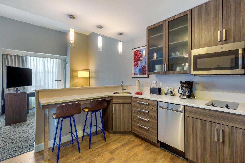 a kitchen with a counter and two bar stools at Residence Inn Providence Downtown in Providence