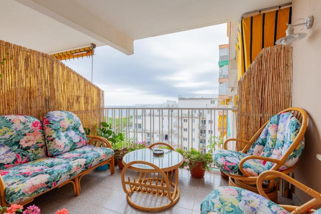 a balcony with chairs and a table on a balcony at Sea view apartments in Malgrat de Mar