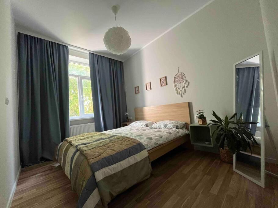 a bedroom with a bed and a potted plant at Apartment Jõesuu in Narva