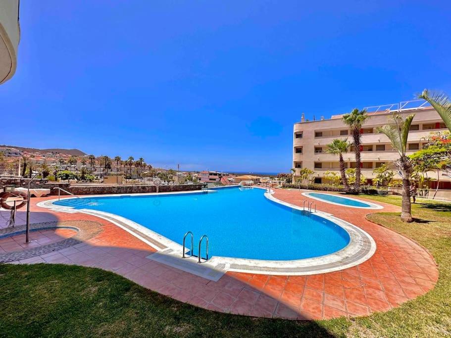 a large swimming pool next to a building at Apartment Amaro, El Palm Mar, Tenerife in Palm-Mar