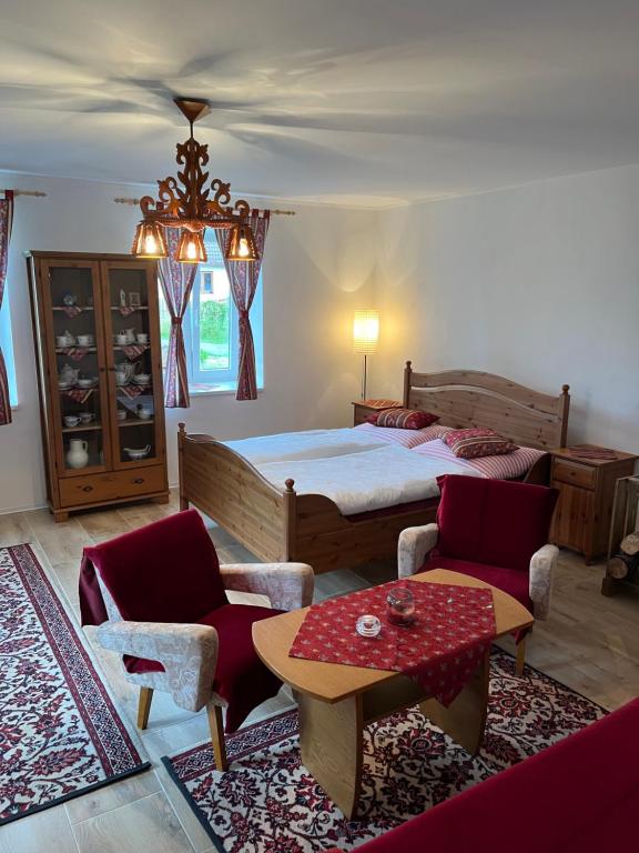 a bedroom with a bed and a table and chairs at Chalupa Františkov 