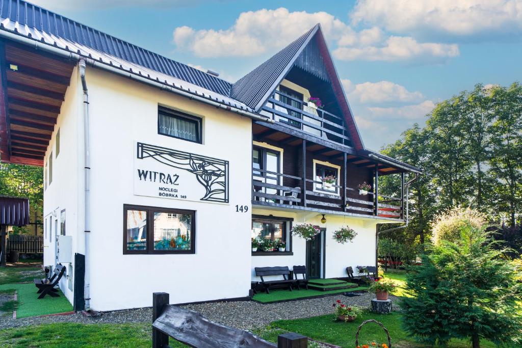 a white house with a black roof at Witraż noclegi Bieszczady in Bóbrka