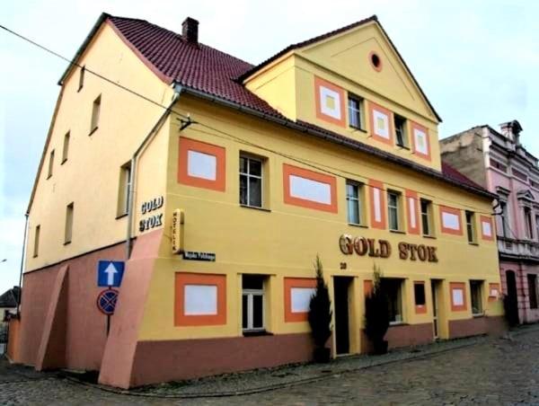 a large yellow building with the words good store at Gold Stok in Złoty Stok