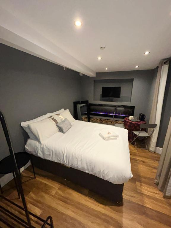 a bedroom with a large bed and a television at Cosy Double Bed With Fire Place in Edinburgh