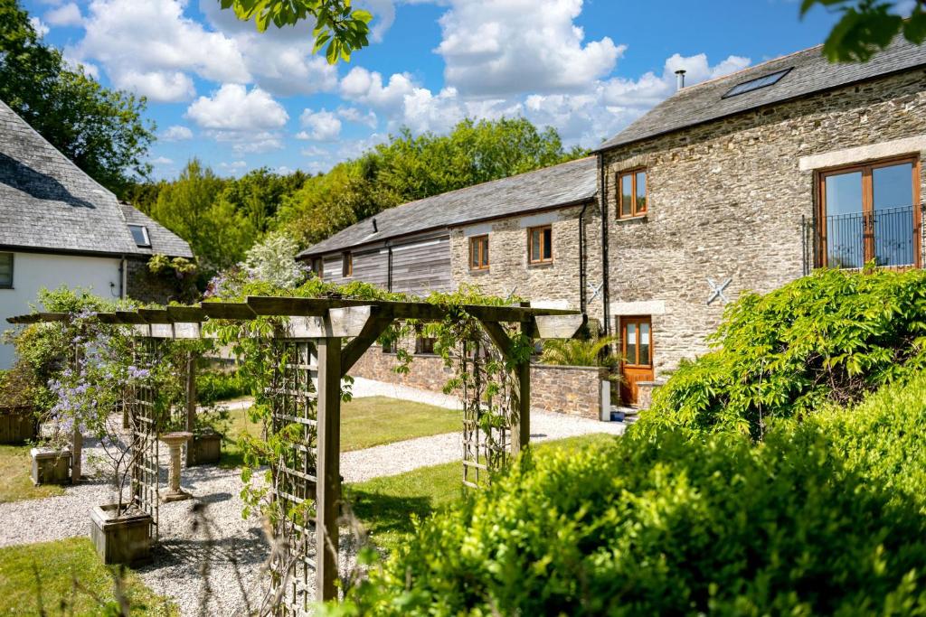 a view of the cottage from the garden at East Trenean Farm Cottages -4 Luxury Cornish Cottages sleeping 20 with hot tubs, private gardens, rural views and EV facilities in Looe