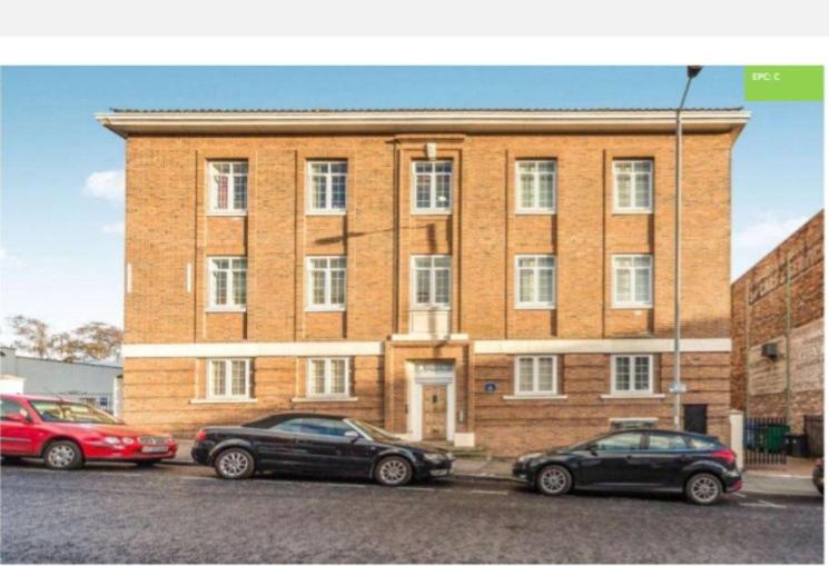 a brick building with cars parked in front of it at 2 bedroom apartment in Kidderminster (The place to be) in Kidderminster