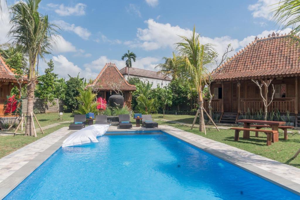a pool in the backyard of a villa at Nunu Bali Eco Friendly Retreat in Canggu