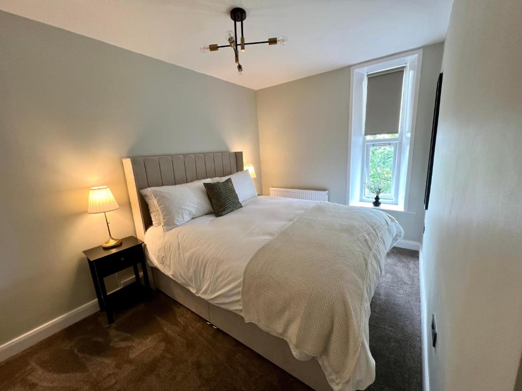 a bedroom with a large bed and a window at The Lookout@brighouse in Brighouse